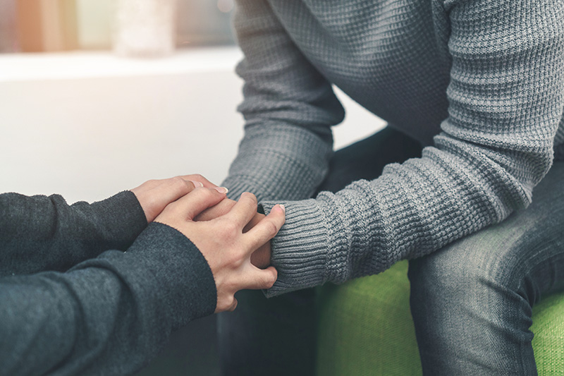 A person celebrates their sobriety with support from a loved one.