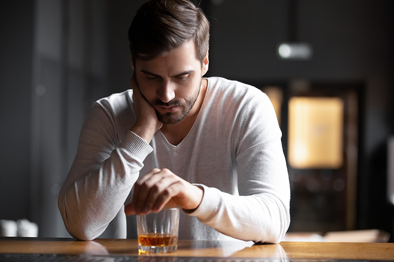 A man struggles with alcohol shakes.