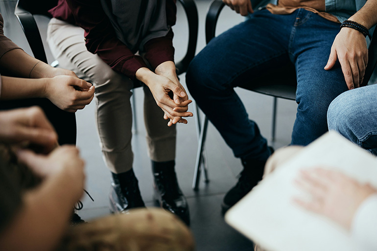 People participate in a peer support meeting.